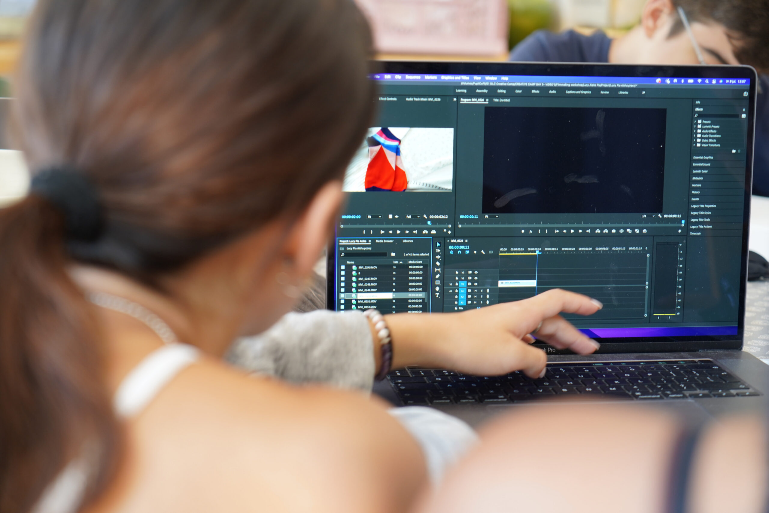 Students editing at creative summer camp