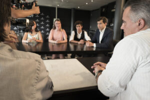 Camera crew filming a business meeting